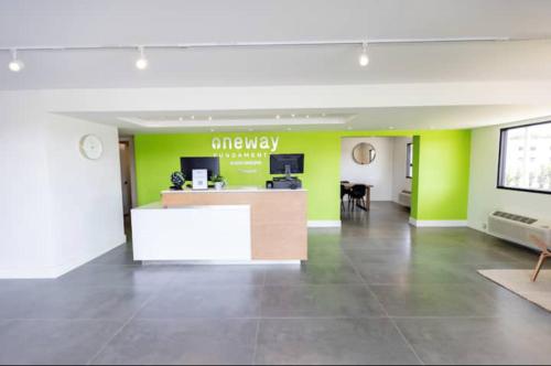 an office lobby with green walls and a desk at Beautiful Room Near Disney/Universal & I-Drive in Kissimmee