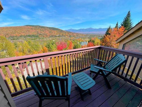 two chairs on a deck with a view of the mountains at CR16 Ski-in/Out luxury home mountain views Bretton Woods in Bretton Woods