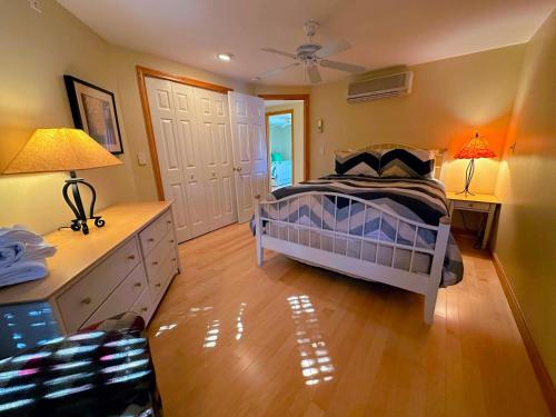 a bedroom with a bed and a table with two lamps at CR16 Ski-in/Out luxury home mountain views Bretton Woods in Bretton Woods