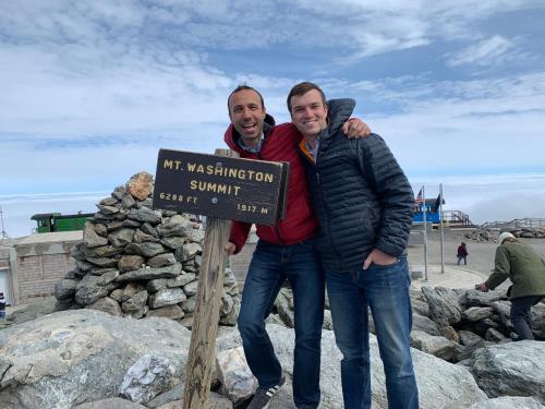 two men standing next to a sign at the beach at CR16 Ski-in/Out luxury home mountain views Bretton Woods in Bretton Woods