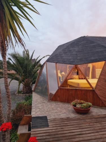 a glass dome shaped house with a bed in it at Domos kupellon in Santiago