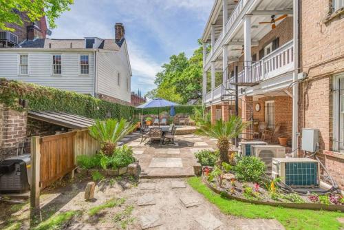 a backyard with a stone patio and a fence at Hamilton Suite 1 - Ground Floor, Courtyard in Savannah
