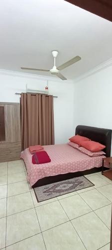 a bed in a room with a ceiling at MZ homestay in Shah Alam