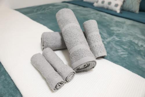 a group of rolled up towels on a bed at Montu Suite Economy Room in Tampa