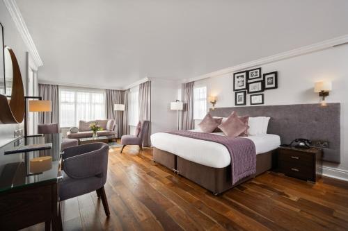 a bedroom with a bed and a living room at Ivanhoe Inn and Hotel in Belfast