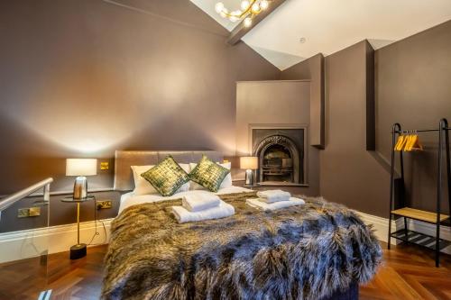a bedroom with a large bed and a fireplace at 34 Coney Street in York
