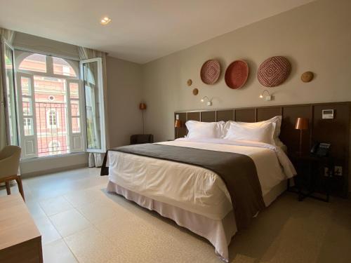 Postel nebo postele na pokoji v ubytování Juma Ópera Boutique Hotel & Spa