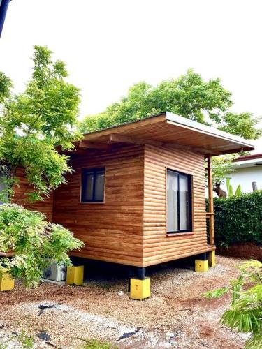 a small house with a roof on top of it at Hoja Azul - Sustainable teak modern cabin in Hojancha in Hojancha
