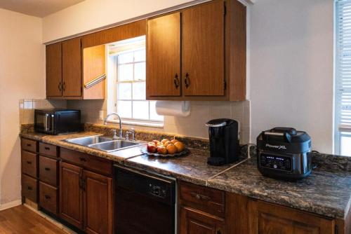 a kitchen with a sink and a counter top at Sheikra Retreat Economy Room in Tampa