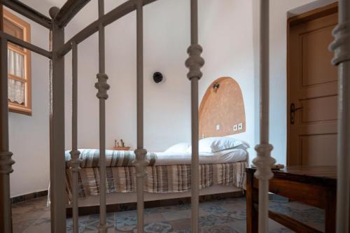 a four poster bed in a bedroom at XARAKI Traditional Houses in Chora Folegandros