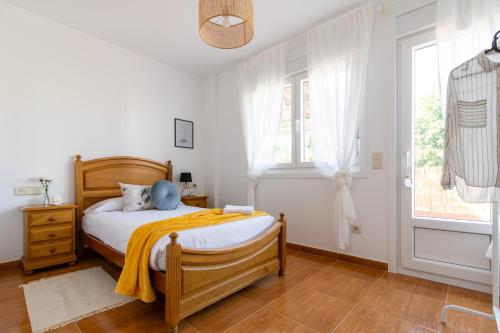 a bedroom with a wooden bed and a window at Senel Home in Boimorto