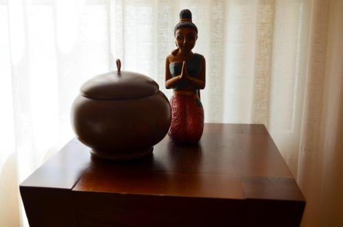 a statue of a woman praying on a table with a vase at The Marbella Heights Boutique Hotel in Marbella