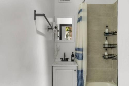 a bathroom with a sink and a shower at Cozy 2BR,1BA Retreat for 6 with Free Parking in Philly in Philadelphia