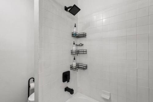 a bathroom with a shower with a toilet and shelves at Center City Philly Home, Cozy 1-BR, Ideal Location for 4 Guests! in Philadelphia