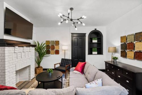 a living room with a couch and a fireplace at Stylish 3BR Philly Retreat with Free Parking in Philadelphia