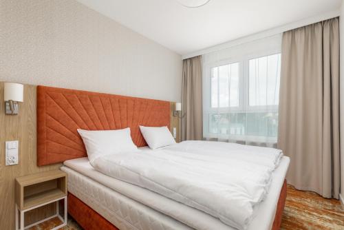 a bedroom with a large bed and a large window at Rent like home - Bel Mare F324 in Międzyzdroje