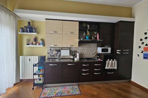 a kitchen with brown cabinets and a counter top at Appartamento Roma Metro A in Rome