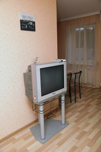 un televisor sentado en un stand en una habitación en студия на пр.Пушкина 1, en Dnipro