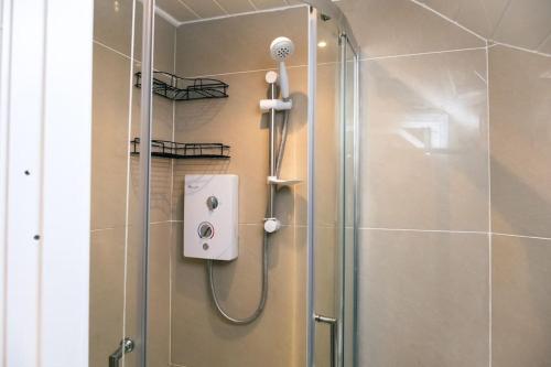 a shower in a bathroom with a glass door at 4 bedroom - Sleep 9 home in Cheadle Staffordshire - Alton towers Polar Express Dimmingsdale Peak District Trentham Gardens Water World in Cheadle