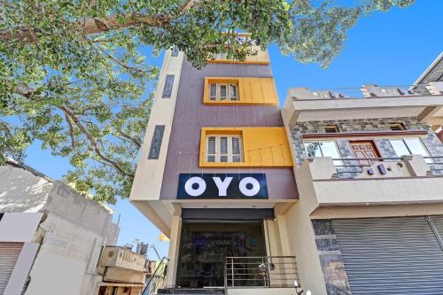 a building with an ovo sign on it at Flagship I Care With Greenery Comforts in Tumkūr