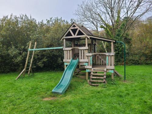 a small playground with a slide and a slideintend at 9 Timber Hill in Broad Haven