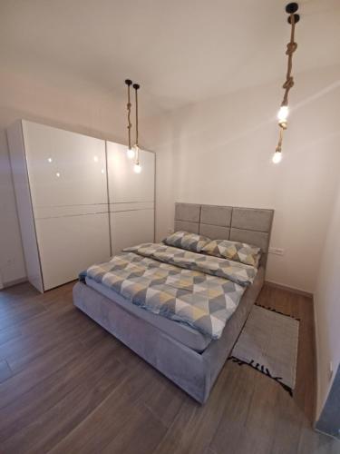 a bedroom with a bed with a checkered mattress at Apartma in Izimje