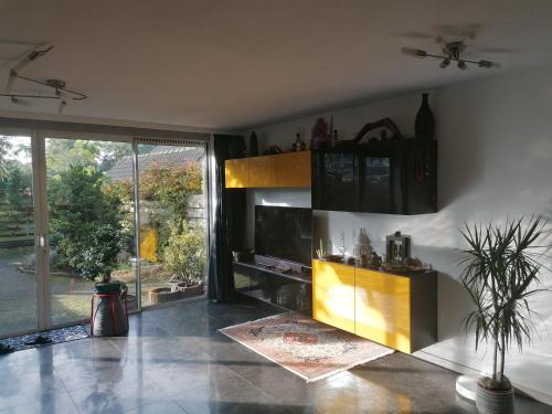 a living room with a fireplace and a large window at Rooms for longer stays with Invoice in Houten