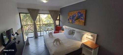 Un dormitorio con una cama grande y una ventana en Elephant Lake Hotel, en St Lucia