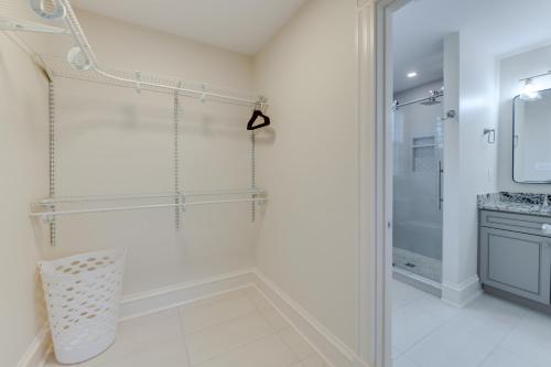 a white bathroom with a shower and a sink at Richmond Home with Patio Walk to Byrd Park! in Richmond