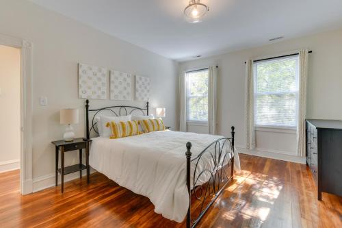 a bedroom with a bed and two windows at Richmond Home with Patio Walk to Byrd Park! in Richmond