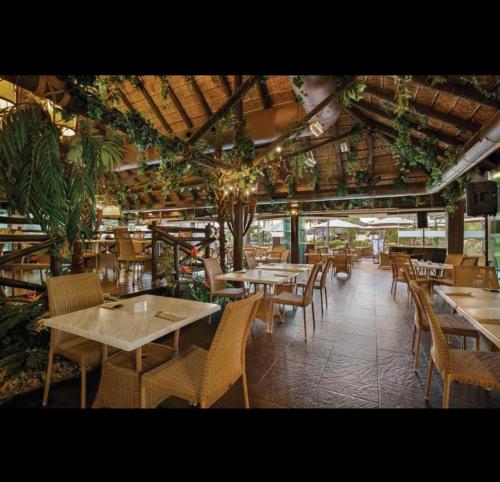 a restaurant with tables and chairs in a room at Marina del Sol apartment by Wyndham in Fuengirola