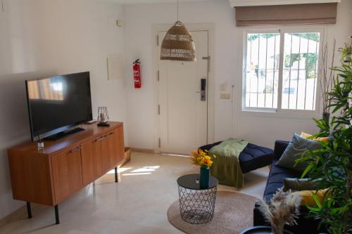 a living room with a flat screen tv and a couch at Marina del Sol apartment by Wyndham in Fuengirola