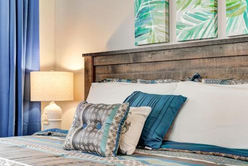 a bedroom with a bed with a wooden headboard and pillows at Classen Craftsman-near Asian & Paseo district in Oklahoma City