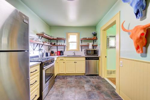 a kitchen with a refrigerator and an animal head on the wall at Canary Cottage-brighten your stay-central NW OKC in Oklahoma City