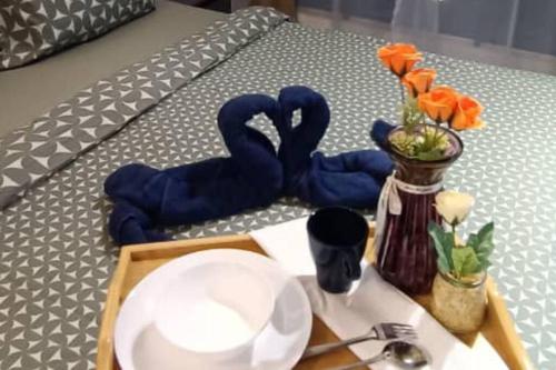 a tray with two blue swans on a bed at High-Floor Sky Trees City Views & Facilities A23 in Johor Bahru