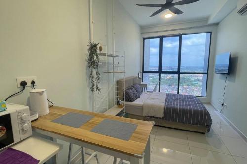 a bedroom with a bed and a table and a window at High-Floor Sky Trees City Views & Facilities A23 in Johor Bahru