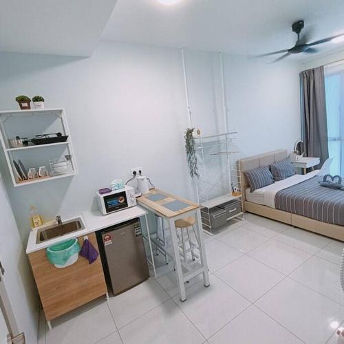 a room with a bed and a kitchen with a table at High-Floor Sky Trees City Views & Facilities A23 in Johor Bahru