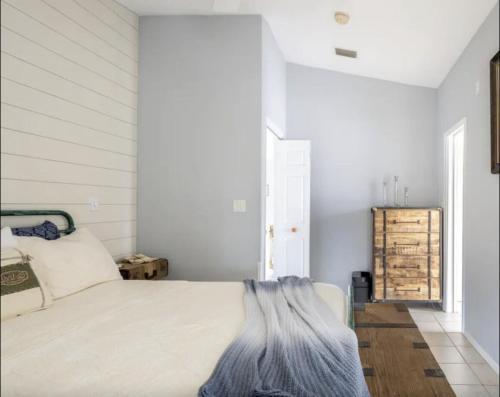 a white bedroom with a bed and a window at Tropical Island Escape Near Disney, Beach, Cruise in Merritt Island