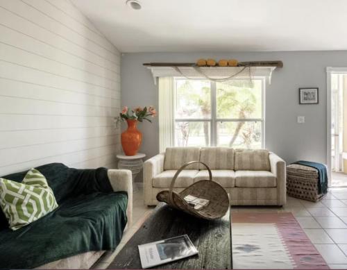 a living room with a couch and a table at Tropical Island Escape Near Disney, Beach, Cruise in Merritt Island