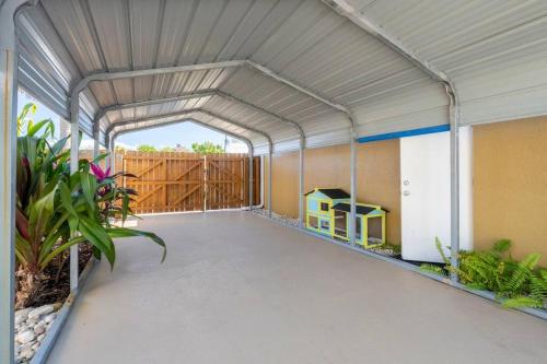 a large metal garage with a play house in it at Tropical Island Escape Near Disney, Beach, Cruise in Merritt Island
