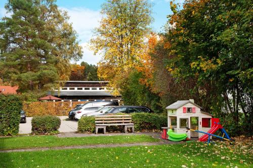 a park with a toy house and a bench at Paulas Ferienwohnung in Füssen