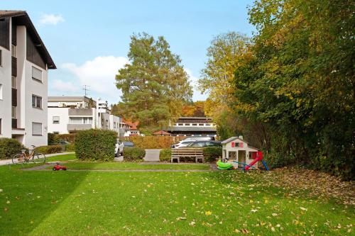 a yard with a house and a frisbee in the grass at Paulas Ferienwohnung in Füssen