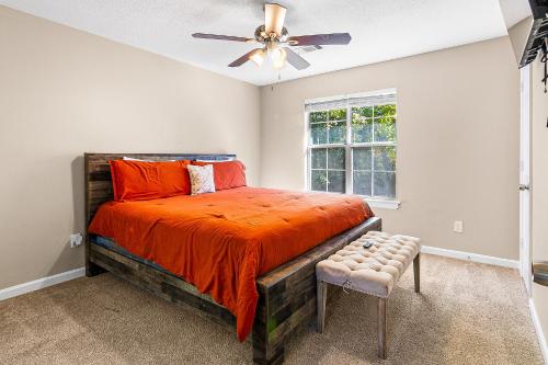a bedroom with a bed and a ceiling fan at Home away from home! Min from the airport and downtown in Atlanta