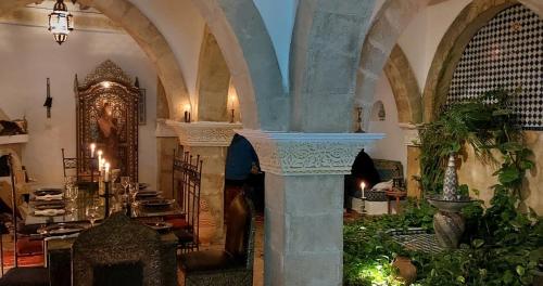 a person standing in a room with a building with an archway at Dar Rahaothello in Essaouira