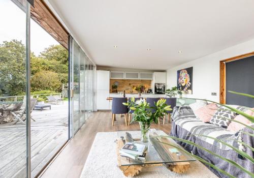a living room with a couch and a table at Chalon - A quirky hideaway on the river for 2 in Cardigan