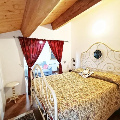 a bedroom with a bed and a window at Appartamento Augusta - Residenza la Madonina in Morciano di Romagna