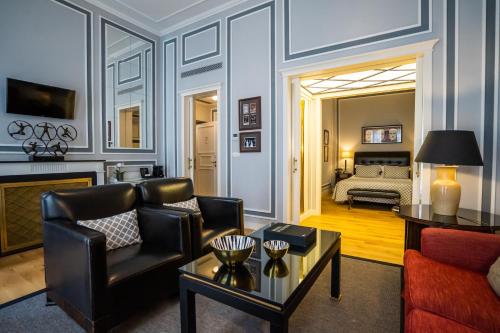 a living room with a couch and a table at Grande Hotel do Porto in Porto