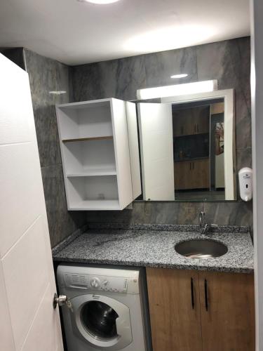 a small kitchen with a sink and a washing machine at Garden park Suit in Beylikduzu