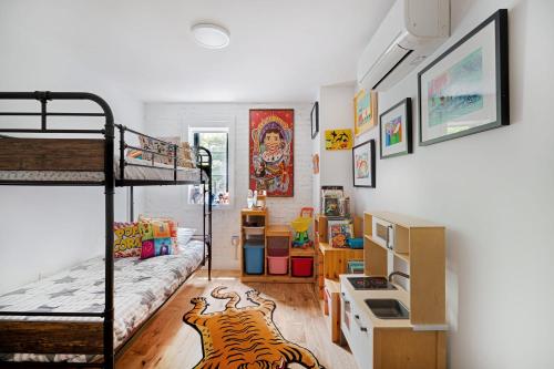 a dorm room with a bunk bed and a desk at 3 BR 1 Bath Prime Williamsburg in Brooklyn