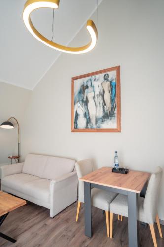 a living room with a couch and a table at Hotel CityHome am Kurpark in Bad Salzuflen
